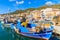 SAMOS PORT, GREECE - SEP 24, 2015: Traditional Greek fishing boats in Samos port on Samos island, Greece. September is most