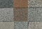 Samples of aggregate concrete patio tiles with pebbles of different colors.