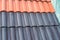 Samples of ceramic roofing tiles in a warehouse of a roofing mat