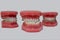 Samples of dentures with porcelain teeth and dental device on a white background