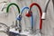 Samples of faucets for bathroom and kitchen in the store. A variety of modern models. Construction and repair. Selective focus