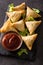 Samsa or samosas with meat and vegetables on black background. Traditional Indian food.