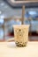 Samut Prakan, Thailand - February 6, 2020 : Iced fresh milk tea with tapioca pearl bubble product from Brown cafe brand at