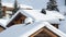 San Bernardino, Switzerland. The roofs of houses covered with fresh snow after heavy snowfall. Mountain and winter contest