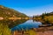 San Cristobal Lake reflections in the water on a nice sunrise morning alpine glow tranquil morning with canoe