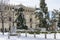 san diego square in the city of alcala de henares snow covered on a sunny day with facade of cisneriana university in the