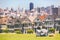 San Francisco - Alamo Square people. Couple tourists relaxing in Alamo Park by the Painted Ladies houses iconic landscape, The
