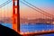 San Francisco Golden Gate Bridge sunrise through cables