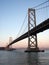 San Francisco side of Bay Bridge at dusk with bird in the air