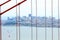 San Francisco skyline viewed through Golden Gate bridge cables