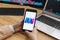 SAN FRANCISCO, US - 18 June 2019: Female Trader Hands Holding the Smartphone Using Application of OOOBTC Cryptocurrency Exchange