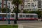 San Francisco, USA - August 13, 2018, the modern tram rides along the evening street with palm trees in cloudy weather in San