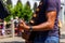 San Francisco, USA - July 15, 2019, male hands and fingers of a guitarist who touch the strings on a brown 6-string