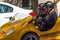 San Francisco, USA - July 18, 2019, joyful tourists close-up in a small yellow car, GoCar is a rental of a 2-seater, 3-wheel car