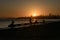 SAN FRANCISCO, USA - OCTOBER 12, 2018: Silhouette of a man fishing at sunrise with downtown background in San Francisco