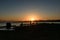 SAN FRANCISCO, USA - OCTOBER 12, 2018: Silhouette of a man fishing at sunrise with downtown background in San Francisco