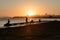 SAN FRANCISCO, USA - OCTOBER 12, 2018: Silhouette of a man fishing at sunrise with downtown background in San Francisco