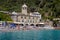 San Fruttuoso di Camogli, Ligurian coast, Genoa province, with its ancient Abbaey, the beach and tourists, Italy