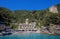 San Fruttuoso di Camogli, Ligurian coast, Genoa province, with its ancient Abbaey, the beach and tourists. Italy.