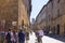 San Gimignano, Italy - 08.26.2017: Ancient millstones in a narrow alley in San Gimignano, Tuscany