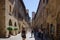 San Gimignano, Italy - 08.26.2017: Ancient millstones in a narrow alley in San Gimignano, Tuscany