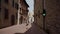 SAN GIMIGNANO, ITALY - MAY 17, 2019: Girl waits for green traffic light street