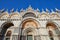 San Marco basilica facade with mosaics in Venice, clear blue sky in Italy