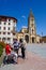 San Salvador Oviedo Cathedral and Alfonso Square. Asturias, Spain. Old women in foreground wearing a Coronavirus face mask