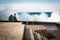 San Sebastian, Spain - March 16, 2018: couple sitting on stone wall admiring scenic huge splash of sea water waves