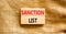 Sanction list symbol. Wooden blocks with concept words Sanction list on beautiful canvas background. Business political sanction