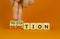 Sanction or negotiation symbol. Businessman turns cubes, changes the word sanction to negotiation. Beautiful orange table, orange