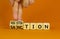 Sanction or negotiation symbol. Businessman turns cubes, changes the word sanction to negotiation. Beautiful orange table, orange