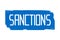 Sanctions word on a blue painted background