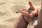 Sand in baby hands. Child playing with beach sand. He has for the first time golden grains of sand in his hands. Infant boy is