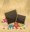 Sand background with photo frames, starfishes, peb