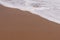 Sand background with wave. Beautiful sand background and wave fr