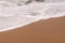 Sand background with wave. Beautiful sand background and wave fr