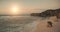 Sand beach with cliff shore of ocean bay aerial. Sunrise above sea waterfront. Sun rise seascape