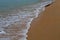 Sand on the beach and foamy water