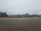 Sand on beach with footprints and buildings in Newport, Oregon