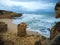 sand beach with rough sea waves and sandstone formation beautiful sandstone cliffs and blue sky background in Algarve Portugal