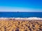 Sand on the beach with the sea and an island in the background. Picture taken on the beach of Benidorm, Spain