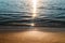 Sand beach and sea wave in sunset light, tranquil summer background