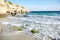 Sand beach, summer sea with blue sky. Sea water with rocks and white waves. Cala azzurra beach, Favignana island, Province of