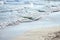 Sand beach, summer sea water with wave. Cala azzurra beach, Favignana island, Sicily, Italy. Wet sand on empty beach