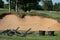 Sand brooms waiting to be put in a bunker on a golf course