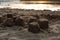 Sand cakes on the beach by the river at sunset, close-up.