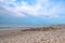 Sand castle on the beach against the background of a pre-sunset summer sky. Summer fun and games