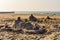 Sand castle buildings on the beach with the ocean in the background, summer season and holidays