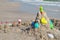 Sand castle toys. The children built a sand pyramid . Games on the beach. Summer school holidays. Beach baby figurines.